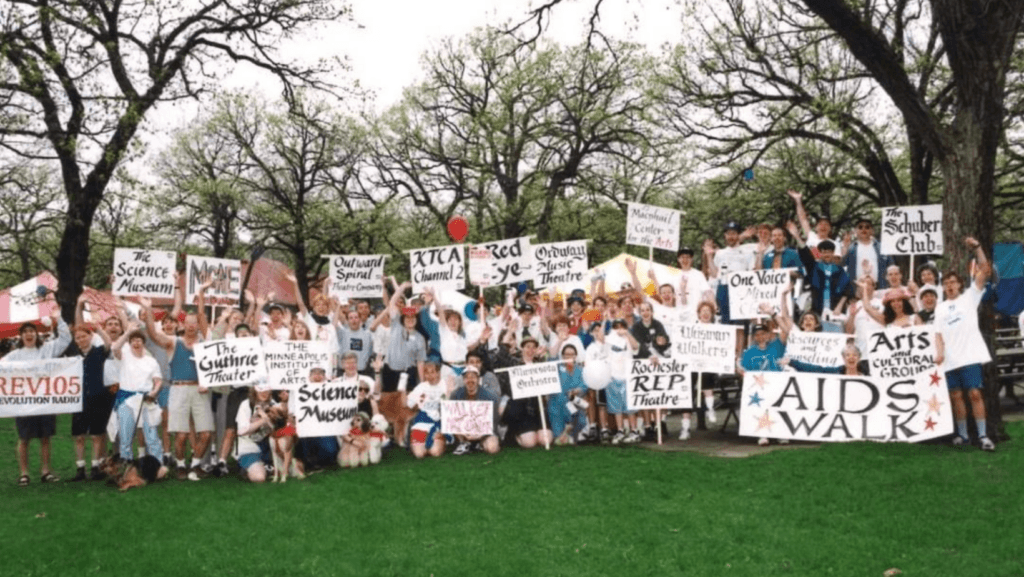 Participants show off their signs at a 1980s AIDS Walk
